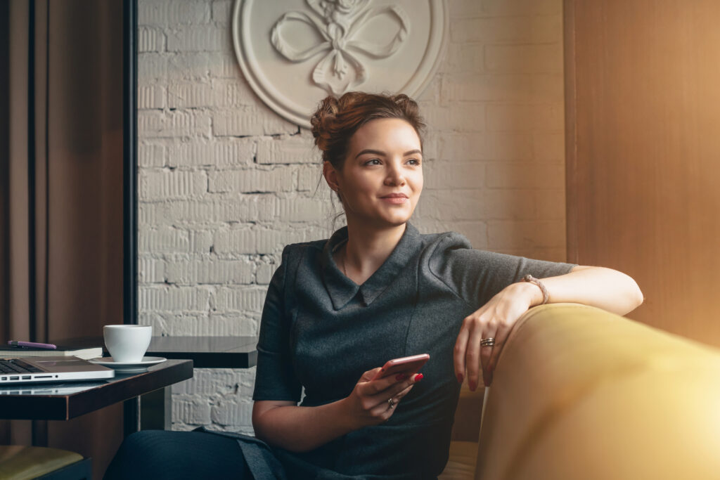 A relaxed woman thinking about the future of her business after getting clear financial information from her bookkeeper.