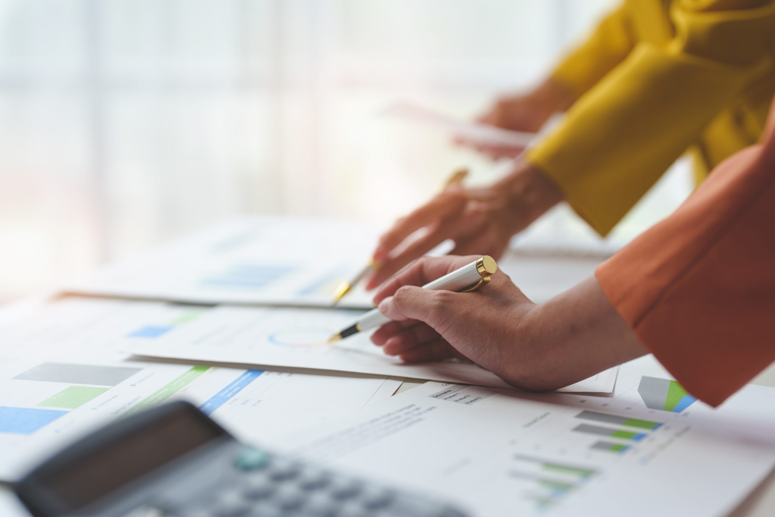 Bookkeepers reviewing non-profit budget to actual financials.